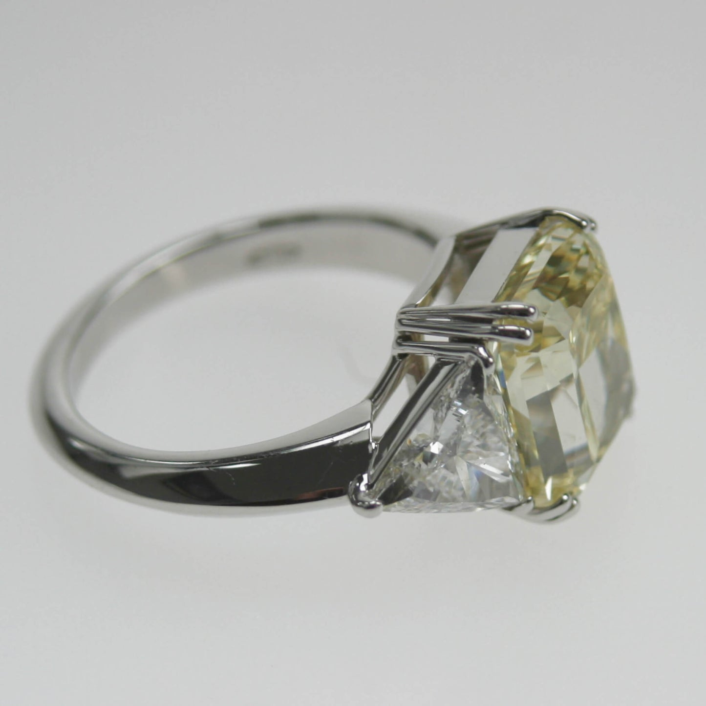 Yellow Emerald-Cut Solitaire Ring with Triangle-Cut Diamond Shoulders