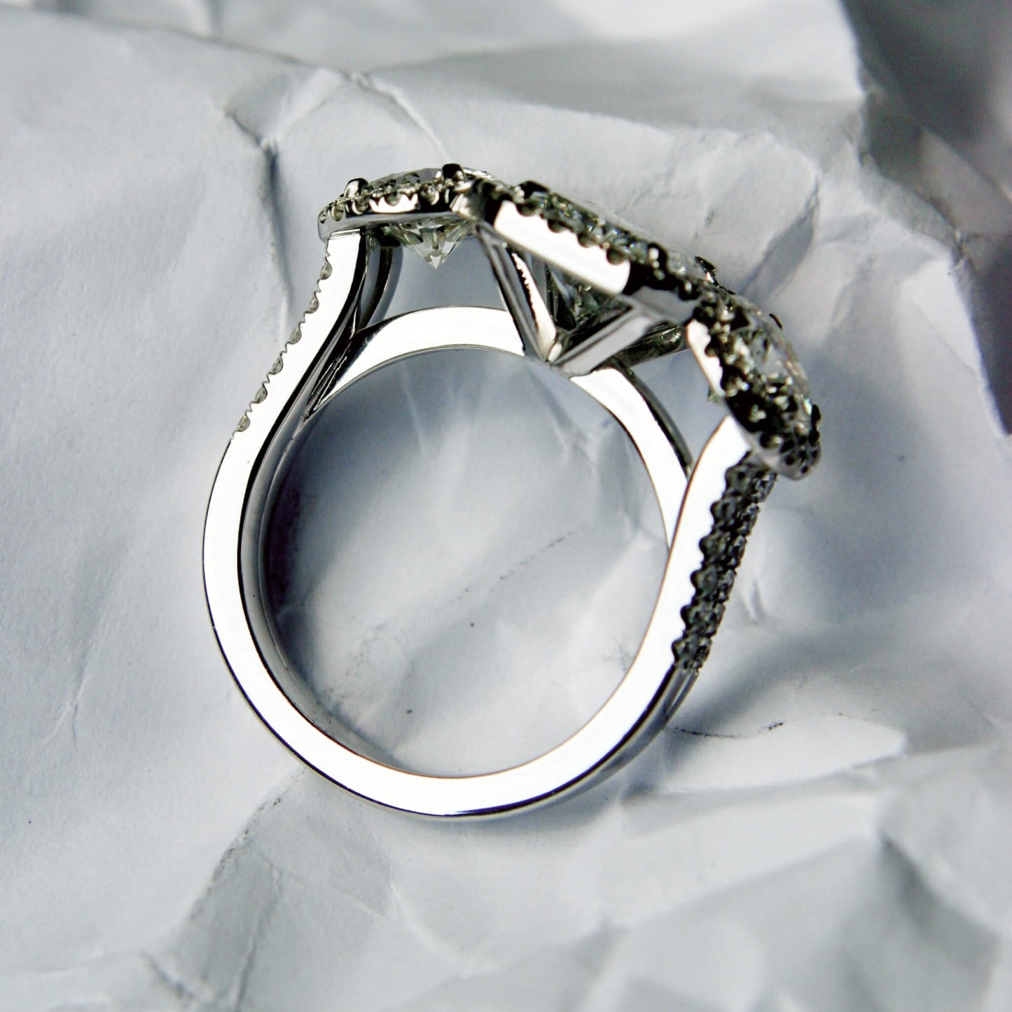 Emerald-Cut Solitaire Ring with Brilliant Diamonds and Castle-Style Pavé Setting