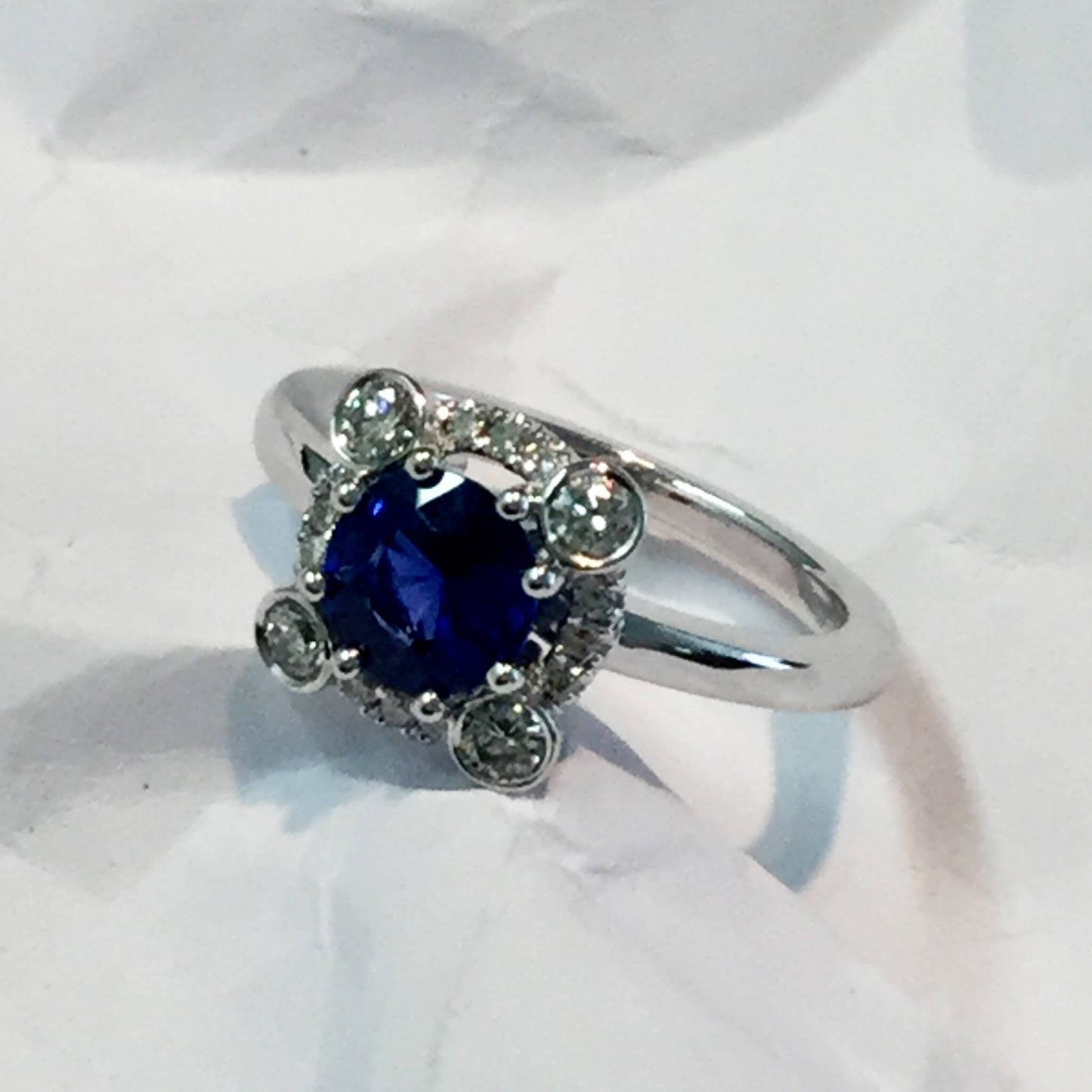 Sapphire Entourage Ring with Larger Diamonds in Closed Setting