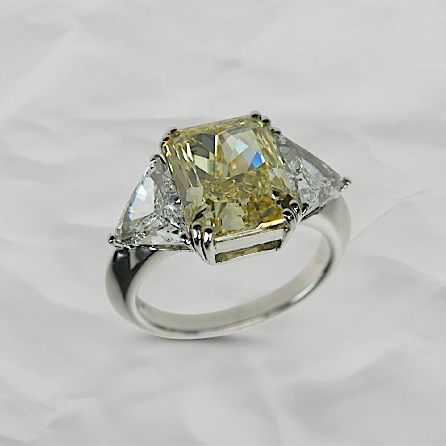 Yellow Emerald-Cut Solitaire Ring with Triangle-Cut Diamond Shoulders