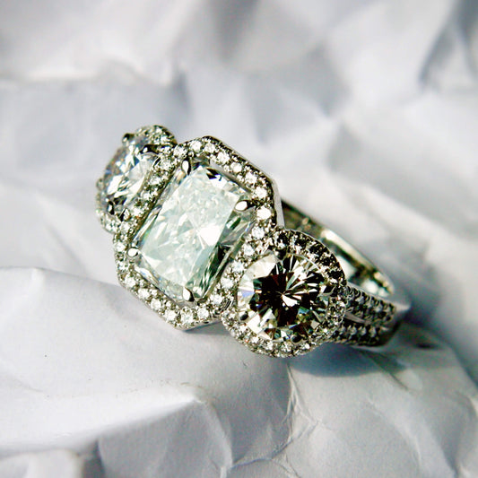 Emerald-Cut Solitaire Ring with Brilliant Diamonds and Castle-Style Pavé Setting